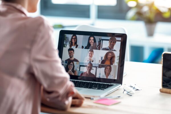 Lady at a laptop on a video call with work colleagues