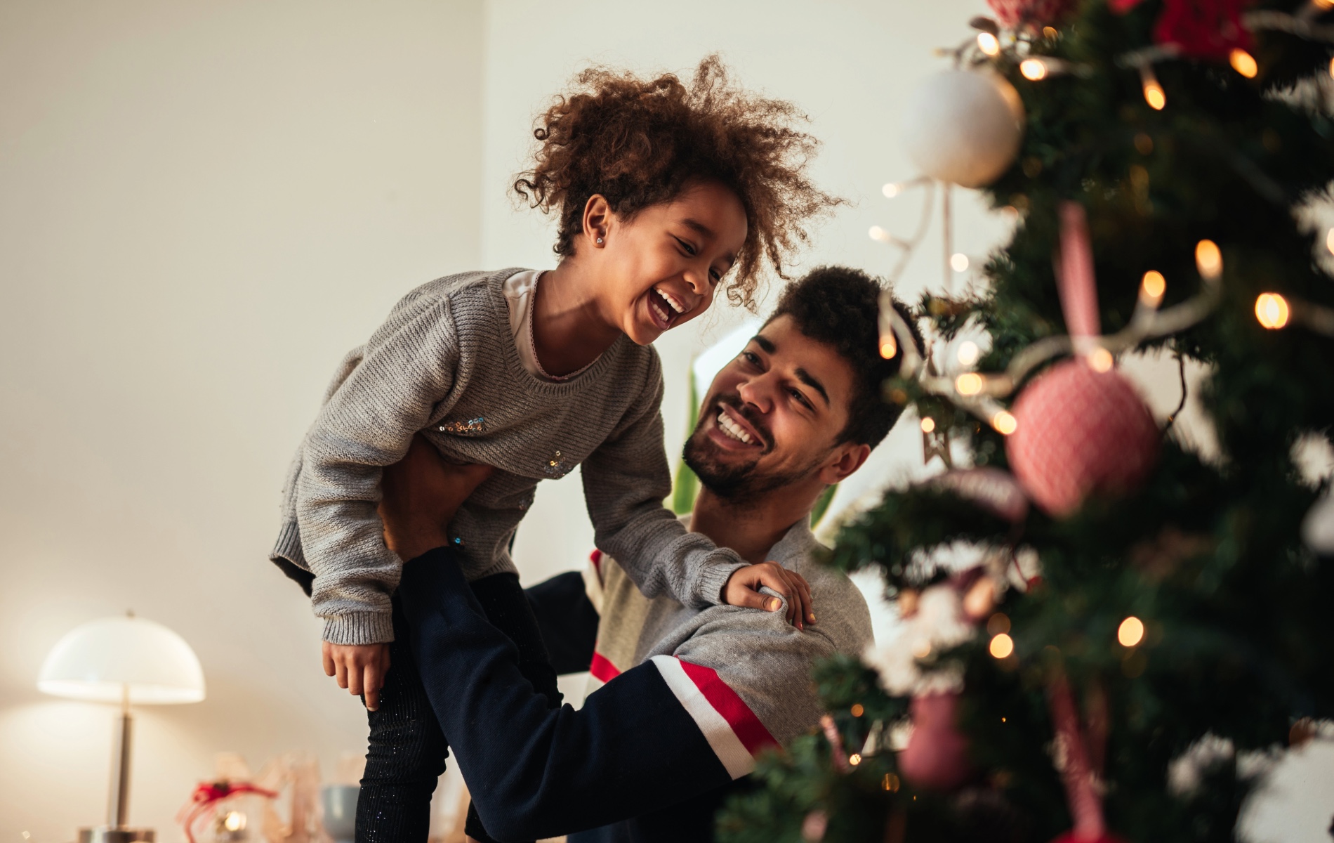 Adult and Child around Christmas tree